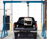Gorbel adjustable gantry crane 2 ton lifting heavy equipment over a black pickup truck