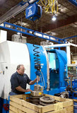 Gorbel G-Force Q and iQ lifting system being used by worker to lift heavy parts in industrial setting