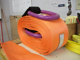 Heavy duty recovery strap with steel rings in bright orange by WiscoLift Inc rolled on a workbench