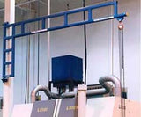 Gorbel wall mounted workstation jib crane in blue installed above industrial machines for lifting